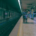 People walking in Kolkata's vibrant Rabindra Sadan metro station.